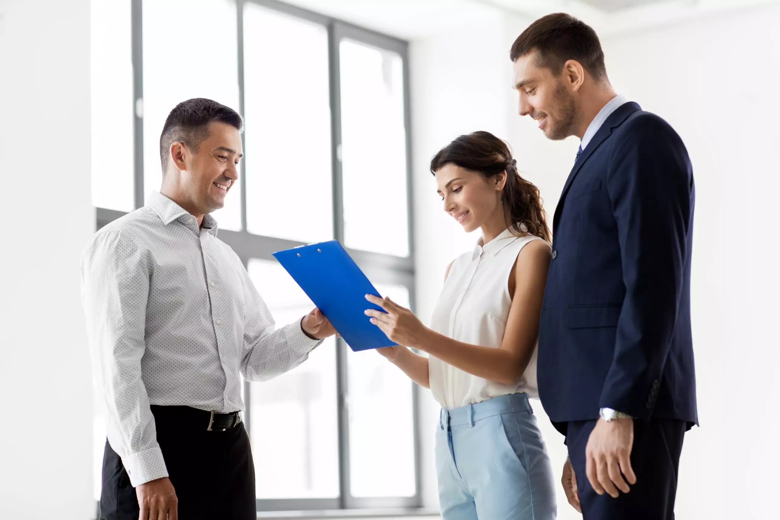 couple looking over paperwork with realtor