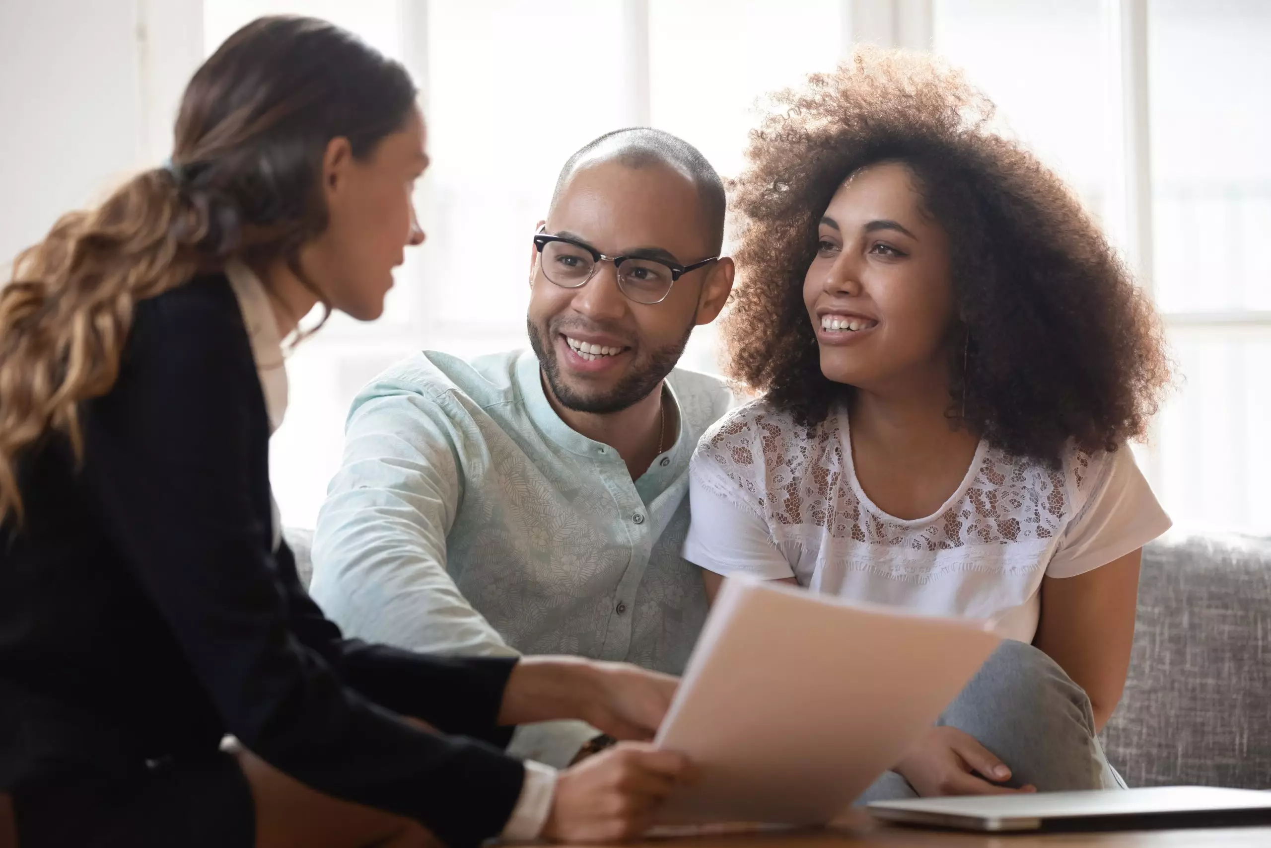 Happy couple talking with realtor